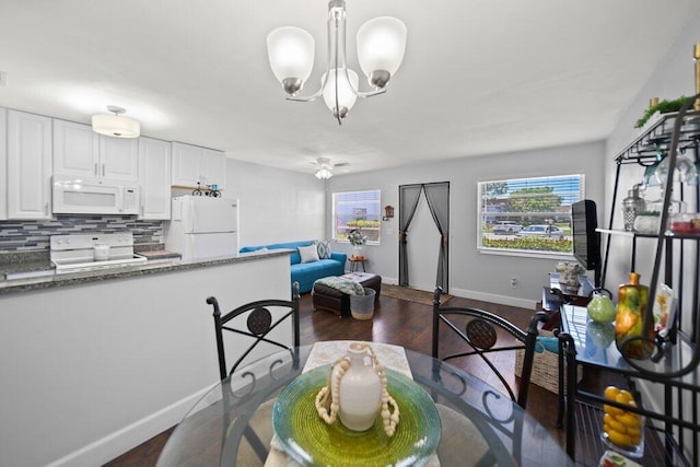 2600 SE Ocean Blvd Unit Jj-6, Stuart, FL 34996 - dining room with a chandelier, dark wood-style floors, and baseboards