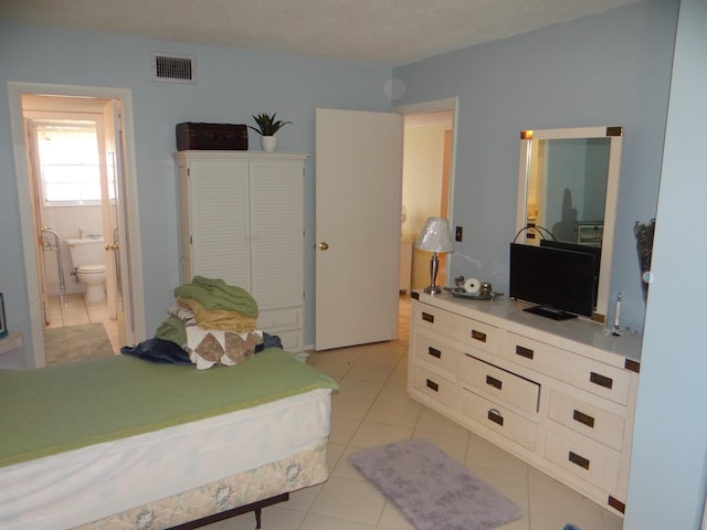 12005 Poinciana Blvd Unit 103, Royal Palm Beach, FL 33411 - bedroom featuring light tile patterned flooring and connected bathroom