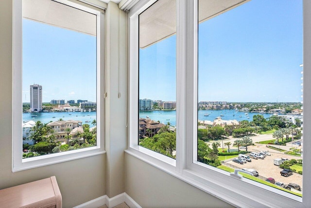 sunroom / solarium featuring a water view