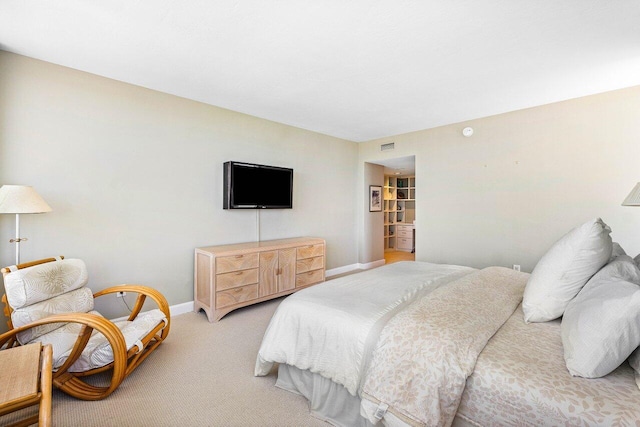 bedroom featuring light colored carpet and baseboards