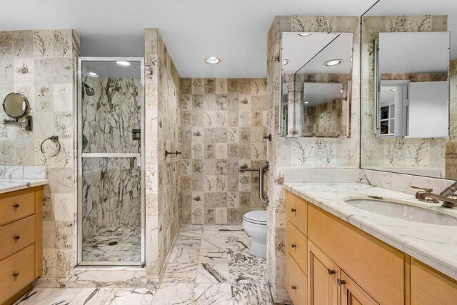 full bath featuring a shower stall, tile walls, vanity, toilet, and recessed lighting