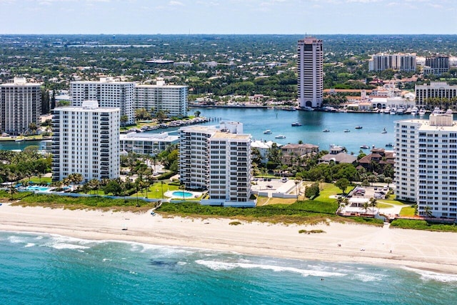 view of urban area featuring waterfront with a beach