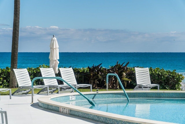 community pool featuring a water view