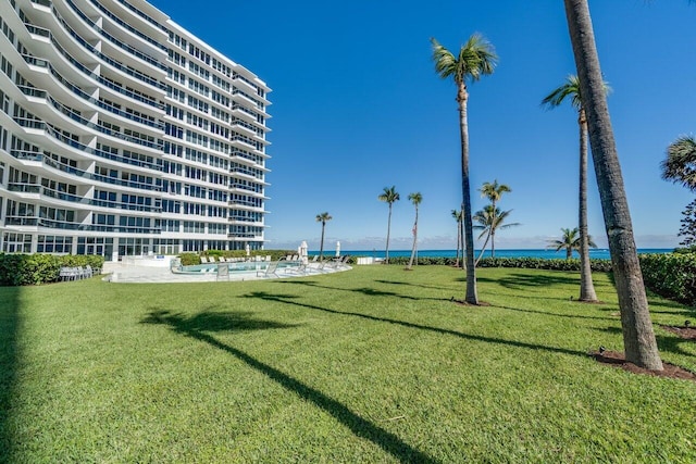 surrounding community featuring a yard and a water view
