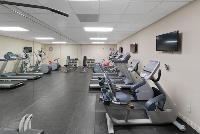 gym with a paneled ceiling