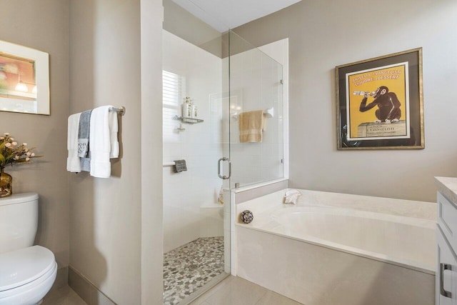 bathroom with a stall shower, toilet, a garden tub, vanity, and tile patterned floors