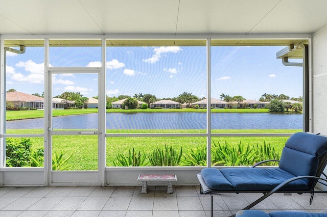 sunroom featuring a water view and a residential view