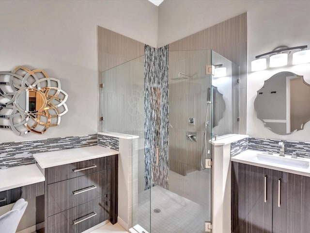 full bath featuring a shower stall, backsplash, and vanity