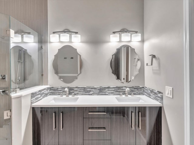 full bath with tasteful backsplash, double vanity, and a shower stall