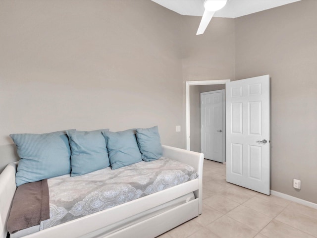 bedroom with light tile patterned floors and baseboards