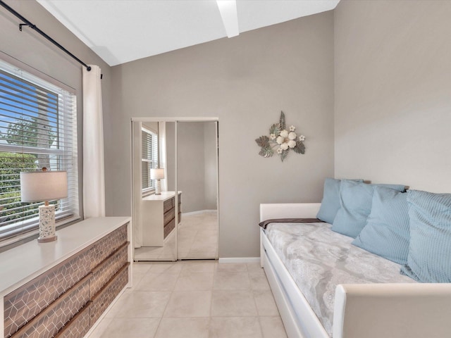bedroom with light tile patterned flooring and baseboards
