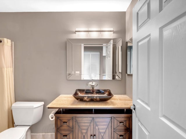 bathroom featuring toilet and vanity