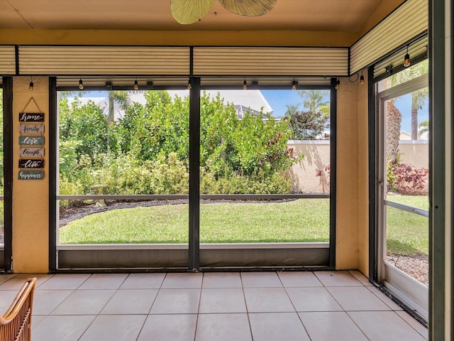 unfurnished sunroom with a ceiling fan