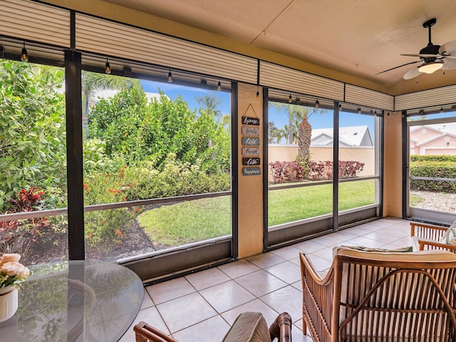 sunroom featuring a ceiling fan