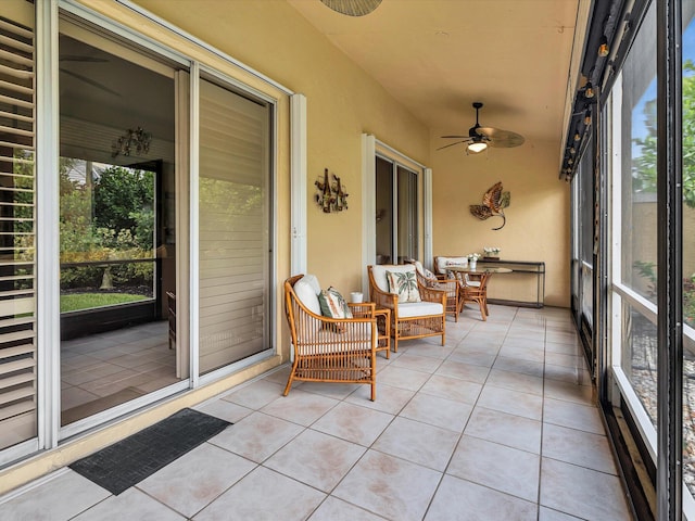 sunroom / solarium featuring a ceiling fan
