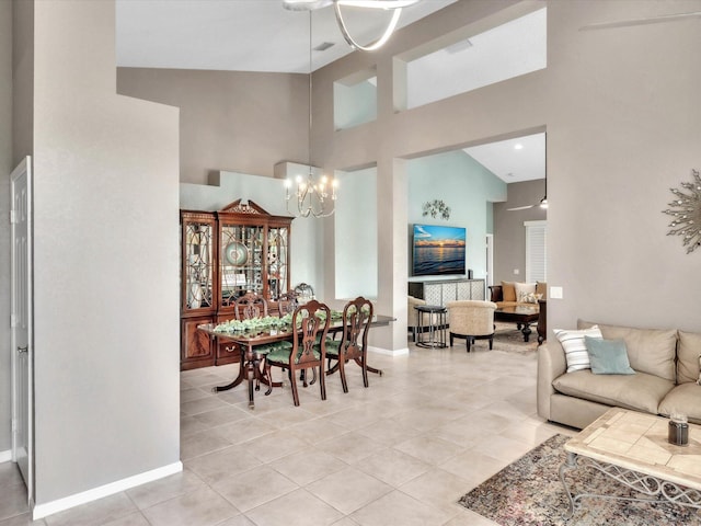 dining area with a chandelier, high vaulted ceiling, light tile patterned floors, and baseboards