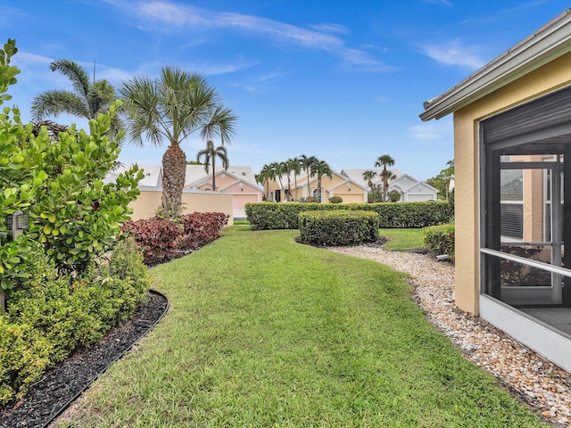view of grassy yard with a residential view