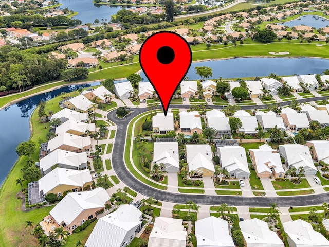 aerial perspective of suburban area with a nearby body of water and a local golf course
