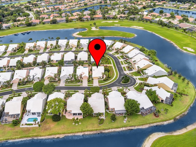 aerial view of property's location with nearby suburban area, a nearby body of water, and a golf club