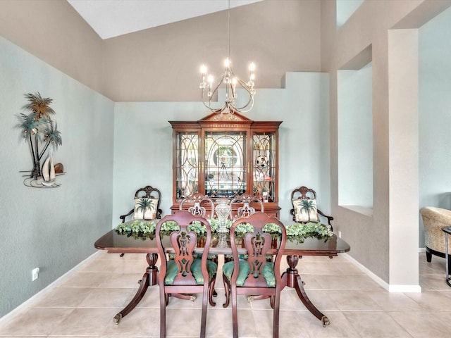 tiled dining room with a chandelier, vaulted ceiling, and baseboards