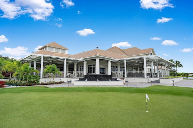 rear view of house featuring a putting green