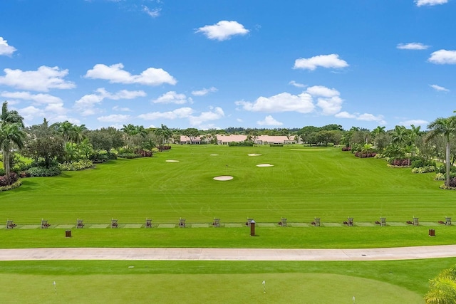 view of home's community featuring view of golf course and view of scattered trees