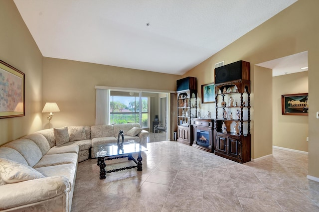 5876 Regal Glen Dr Unit 209, Boynton Beach, FL 33437 - tiled living room with vaulted ceiling, a glass covered fireplace, and baseboards