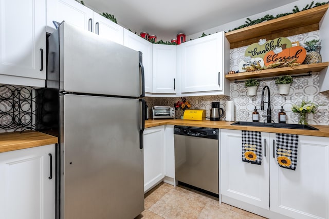 9930 Pineapple Tree Dr Unit 202, Boynton Beach, FL 33436 - kitchen featuring appliances with stainless steel finishes, open shelves, butcher block countertops, and a sink