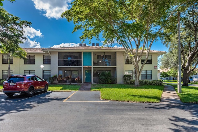 9930 Pineapple Tree Dr Unit 202, Boynton Beach, FL 33436 - view of building exterior with uncovered parking
