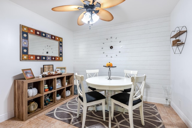 9930 Pineapple Tree Dr Unit 202, Boynton Beach, FL 33436 - dining area featuring ceiling fan, baseboards, wooden walls, and light tile patterned floors