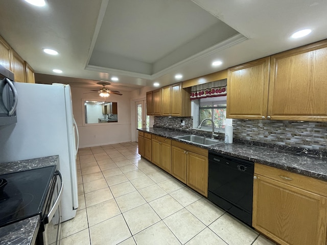 7301 Cabana Ln, Fort Pierce, FL 34951 - kitchen with black appliances, a sink, a tray ceiling, decorative backsplash, and light tile patterned flooring