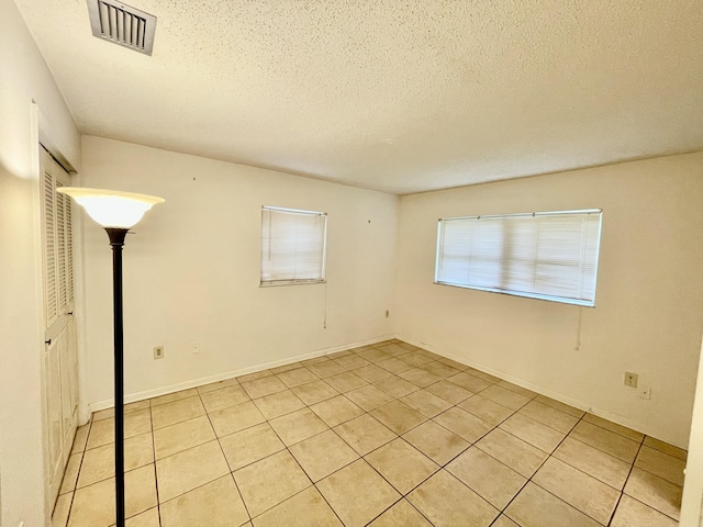 7301 Cabana Ln, Fort Pierce, FL 34951 - empty room featuring light tile patterned flooring and a textured ceiling