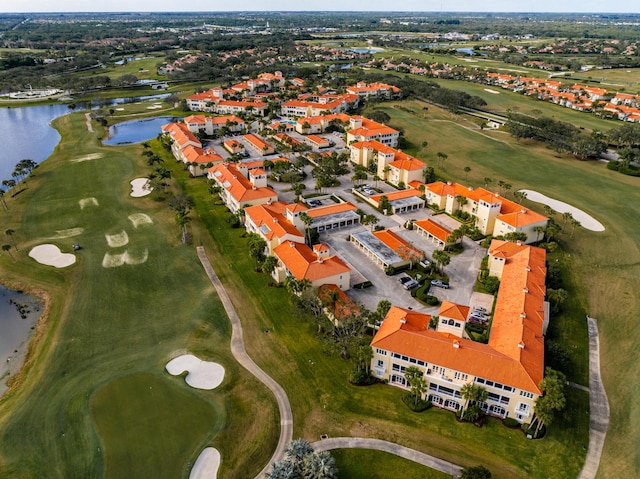 view of property location featuring a nearby body of water and a golf club