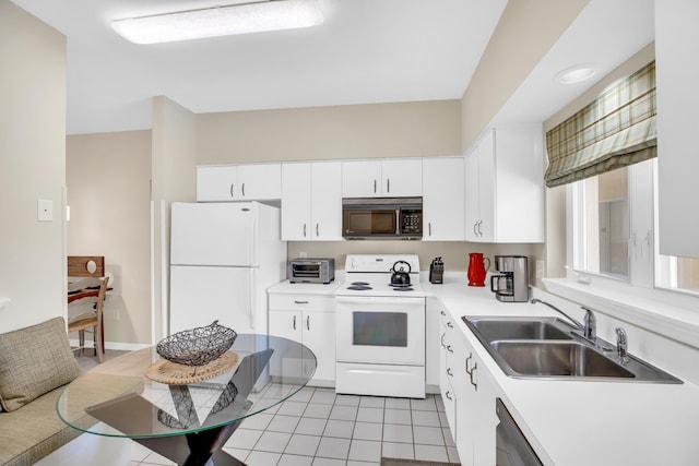 kitchen featuring white appliances, a sink, white cabinetry, light countertops, and light tile patterned floors