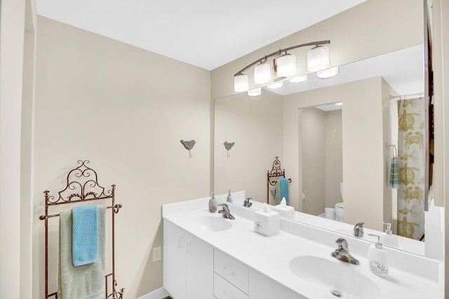 full bath featuring toilet and double vanity