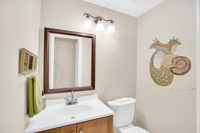 bathroom with toilet and vanity