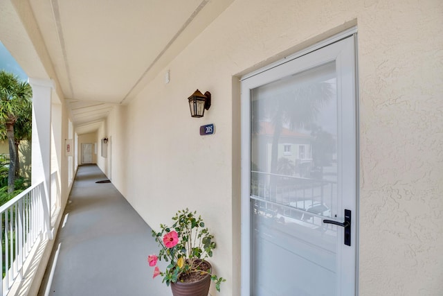 doorway to property featuring stucco siding