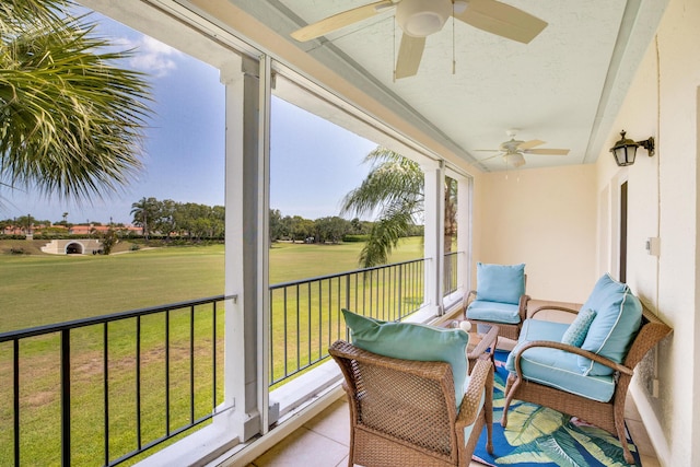 sunroom / solarium featuring ceiling fan