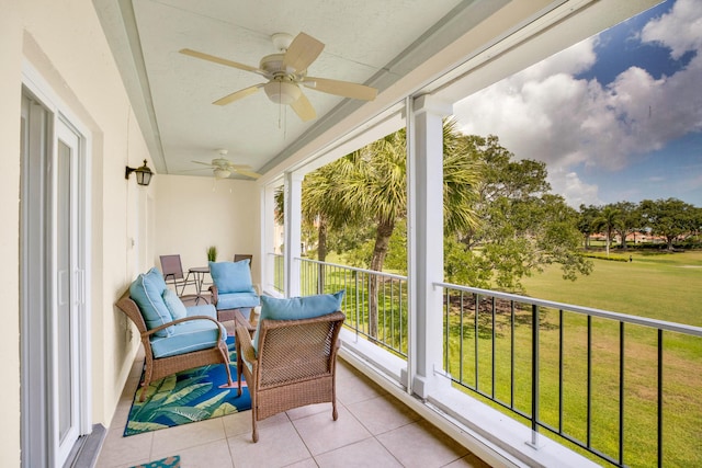 sunroom / solarium with a ceiling fan