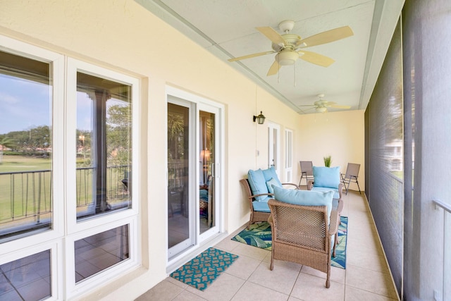sunroom featuring a ceiling fan, french doors, and tile patterned flooring