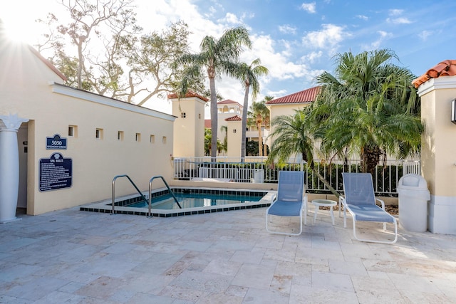 view of swimming pool with fence and a patio area