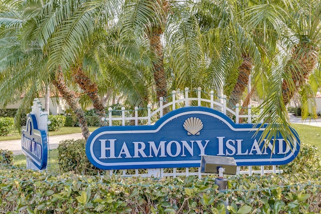 community / neighborhood sign featuring fence