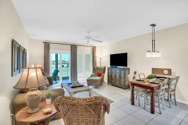 living area with ceiling fan, light tile patterned floors, and baseboards