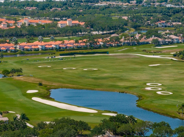 surrounding community featuring a water view, golf course view, and view of wooded area