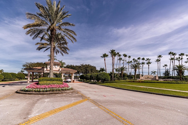 view of asphalt road with curbs