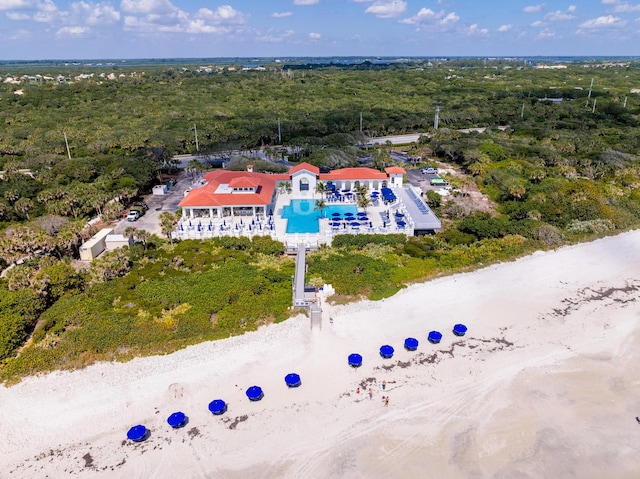 bird's eye view of a heavily wooded area and a pool area