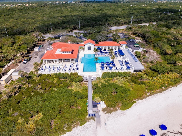 bird's eye view of a heavily wooded area and a pool area