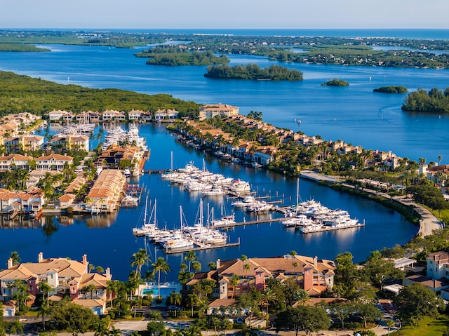 drone / aerial view of a marina and a nearby body of water