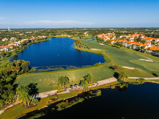 aerial view of residential area with a large body of water and a local golf course