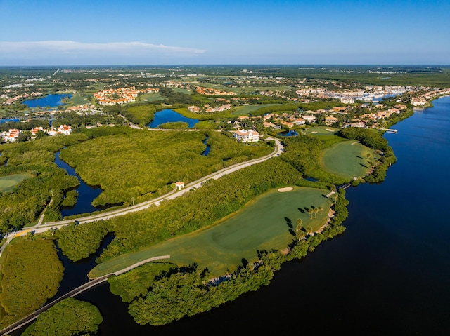 aerial overview of property's location with a nearby body of water and a golf course